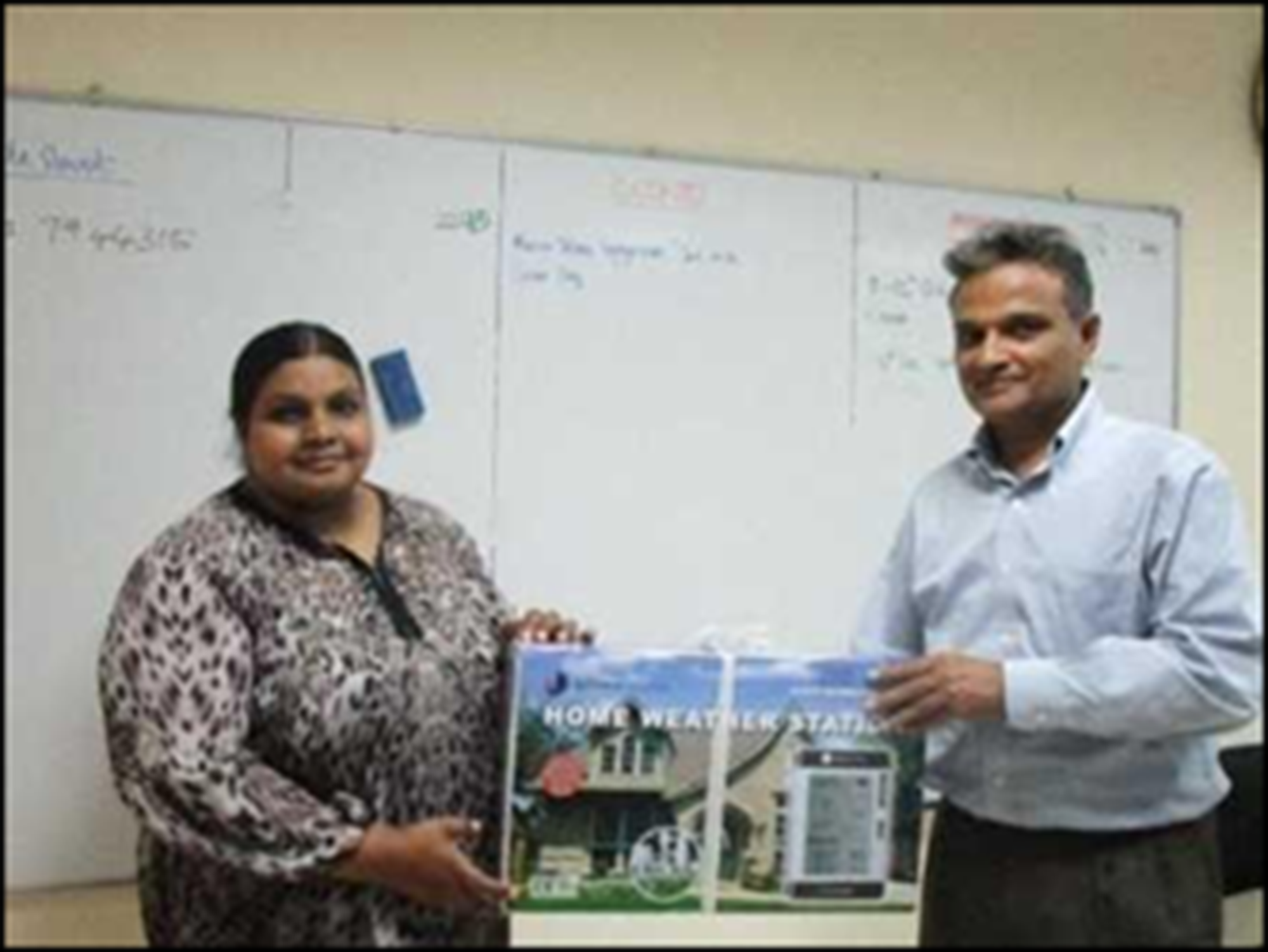 Dr.  Shazla Mohamed, Dean, Faculty of Science, MNU receiving the Automatic weather station from Dr. Lareef Zubair